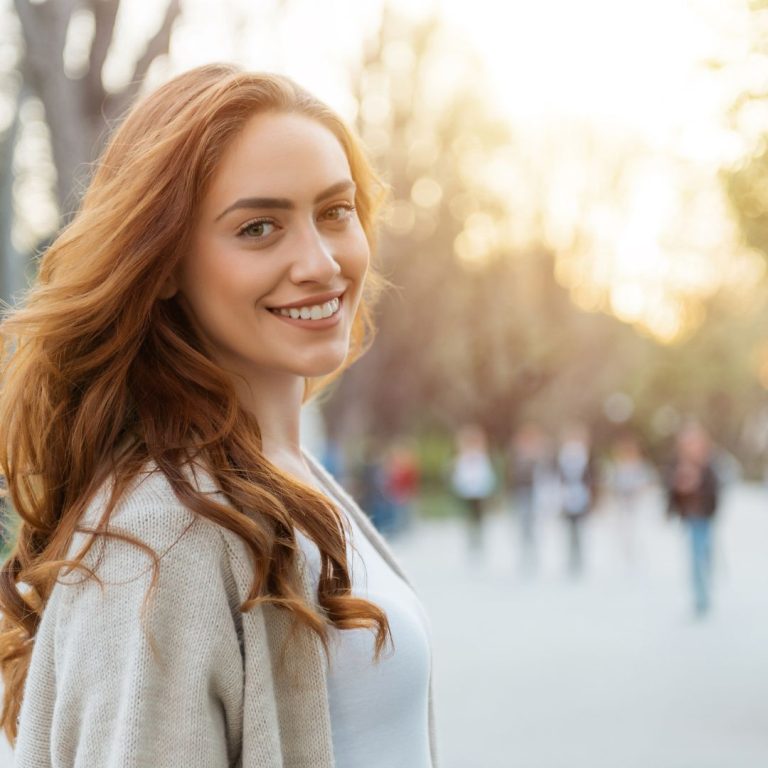 Happy Scullion LAW client smiles with people blurred in the background